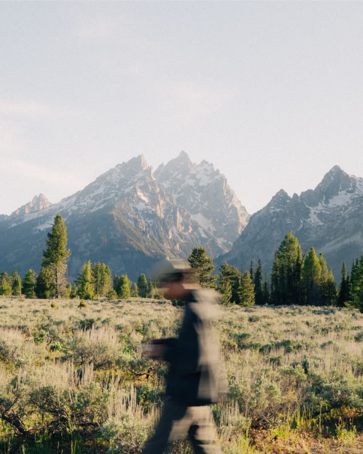 A person walking through a mountain landscape